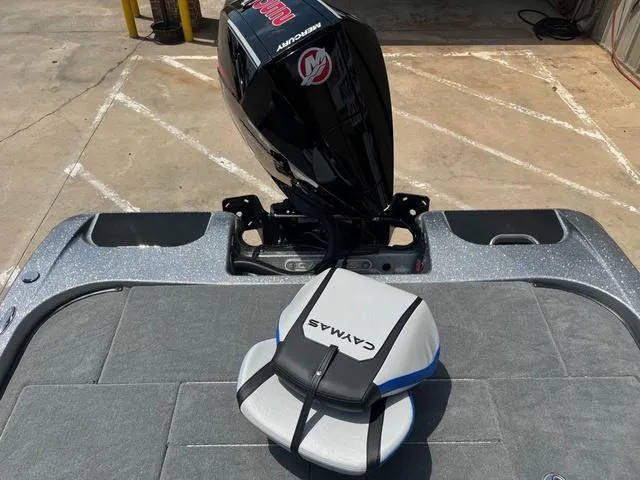Slide: The Image of 2025 Caymas CX21 Pro boat with Mercury engine, featuring a cushioned seat on deck. - 11