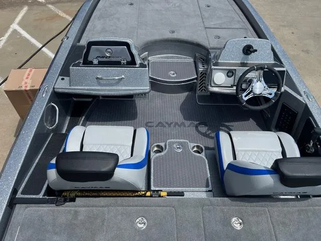 Slide: The Image of 2025 Caymas CX21 Pro boat interior with modern seating and steering console. - 12