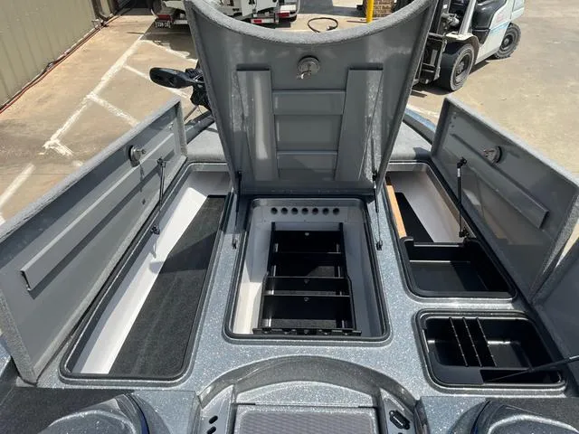 Slide: The Image of 2025 Caymas CX21 Pro boat storage compartments open, showcasing organized interior layout. - 16