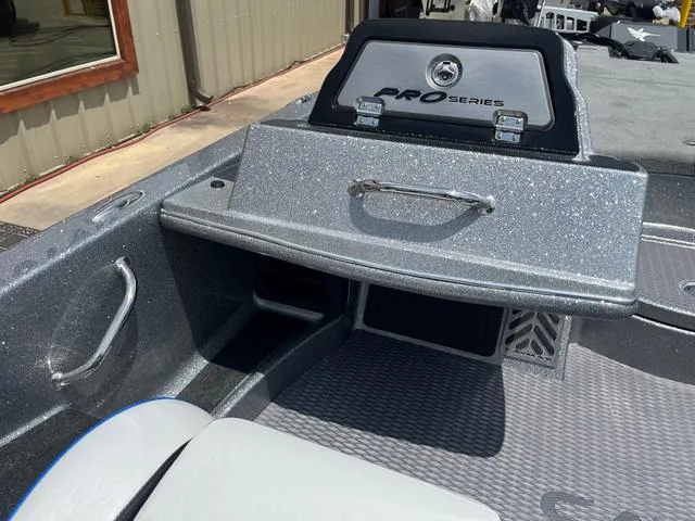 Slide: The Image of 2025 Caymas CX21 Pro boat interior with Pro Series dashboard and storage compartments. - 18