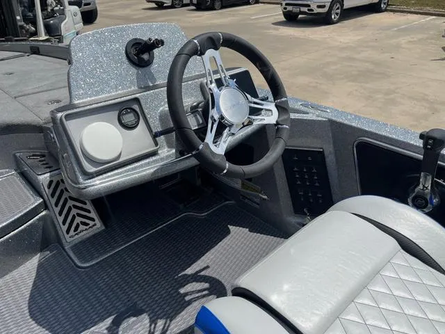 Slide: The Image of 2025 Caymas CX21 Pro boat interior with modern steering wheel and dashboard controls. - 19