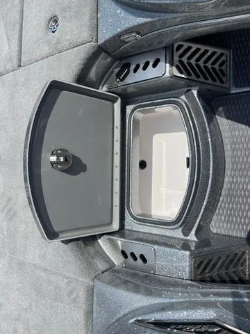 Slide: The Image of 2025 Caymas CX21 Pro boat storage compartment with open lid, showcasing interior design. - 21