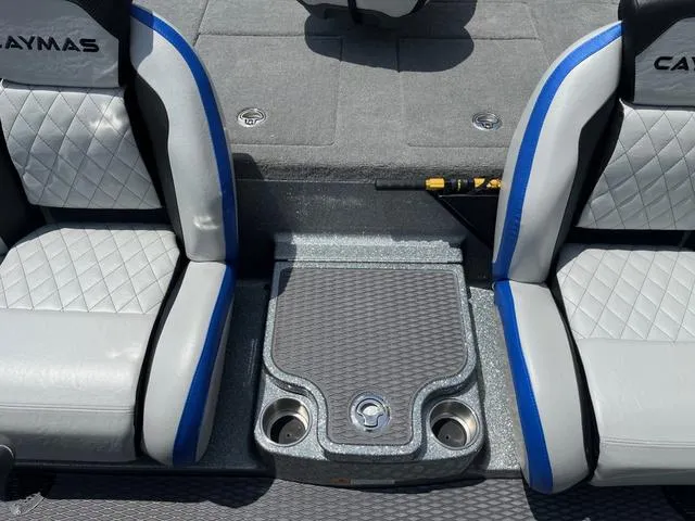 Slide: The Image of 2025 Caymas CX21 Pro boat interior with gray and blue seats, featuring a central console. - 22