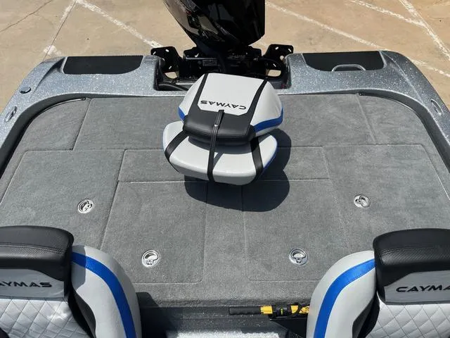 Slide: The Image of 2025 Caymas CX21 Pro boat interior with gray carpet and branded seating. - 24