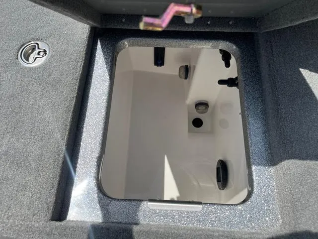 Slide: The Image of 2025 Caymas CX21 Pro boat storage compartment with open lid, showcasing interior details. - 25