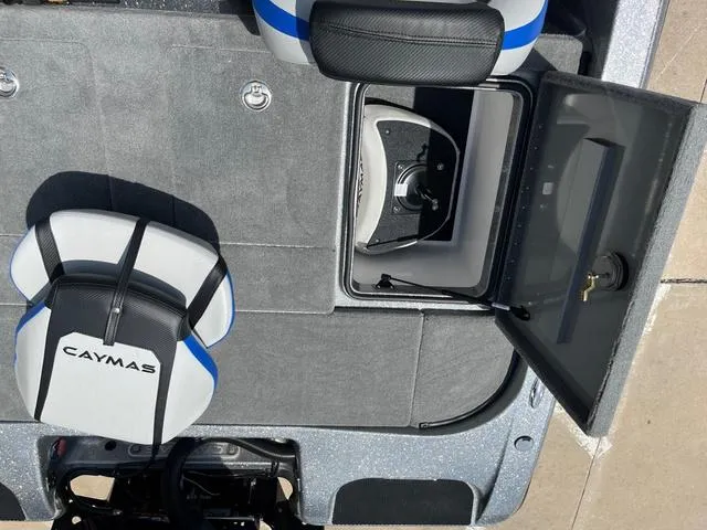 Slide: The Image of 2025 Caymas CX21 Pro boat interior with open storage compartment and seating. - 28