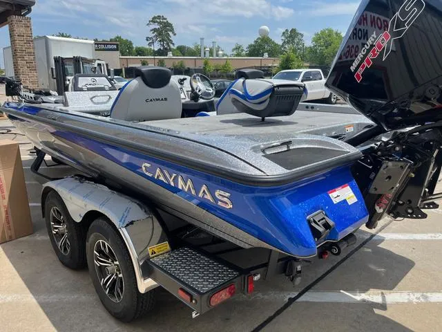 Slide: The Image of 2025 Caymas CX21 Pro boat in blue, parked on a trailer in a lot. - 30