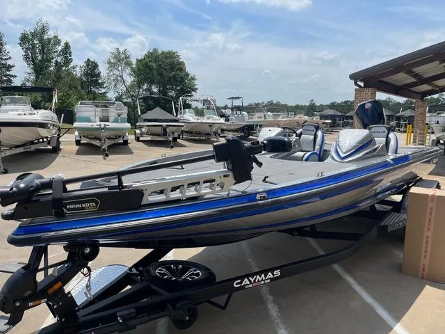 Slide: The Image of 2025 Caymas CX21 Pro boat on trailer, parked in marina with other boats. - 4