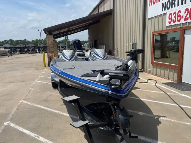 Slide: The Image of 2025 Caymas CX21 Pro boat parked outside a building on a sunny day. - 5