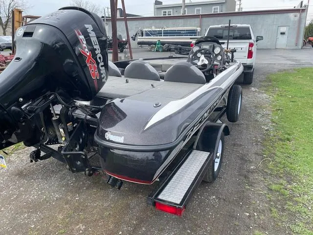Slide: The Image of 2013 Nitro Z-6 boat with Mercury engine on trailer, parked outdoors. - 3