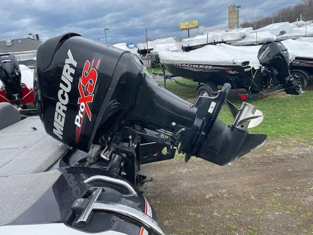 Slide: The Image of 2013 Nitro Z-6 boat with Mercury Pro XS outboard motor, parked outdoors. - 5