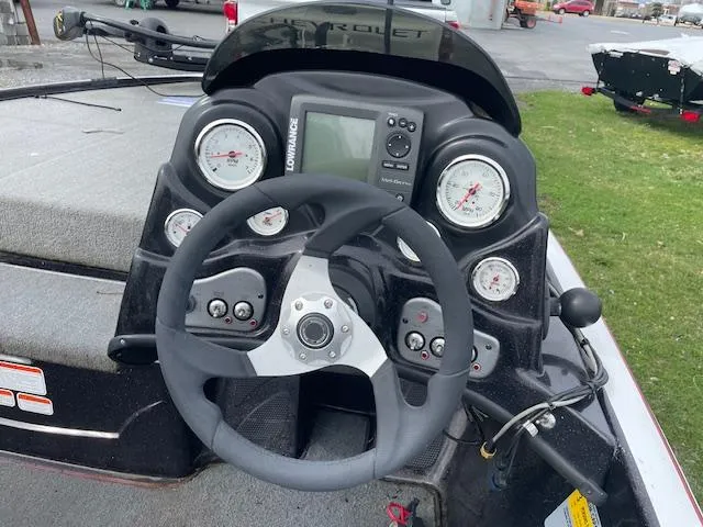 Slide: The Image of Steering console of a 2013 Nitro Z-6 boat with gauges and controls. - 6