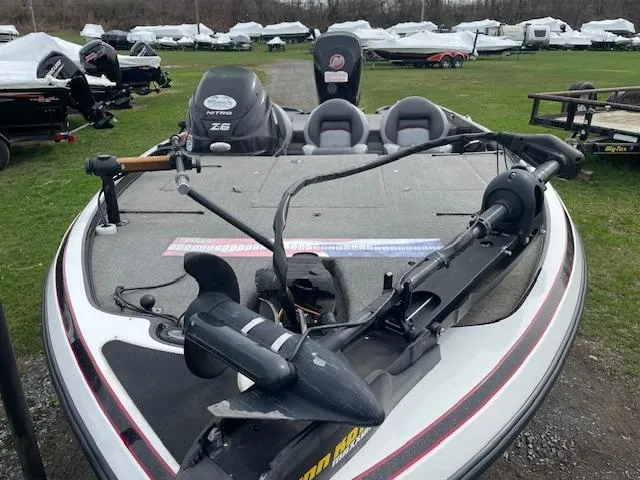 Slide: The Image of 2013 Nitro Z-6 boat with dual seats and motor, parked on grass. - 7