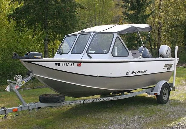 Slide: The Image of 2003 Hewescraft 160 Sportsman boat on trailer, parked outdoors. - 1