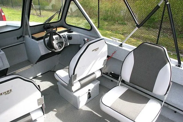 Slide: The Image of 2003 Hewescraft 160 Sportsman boat interior with steering wheel and seating. - 6
