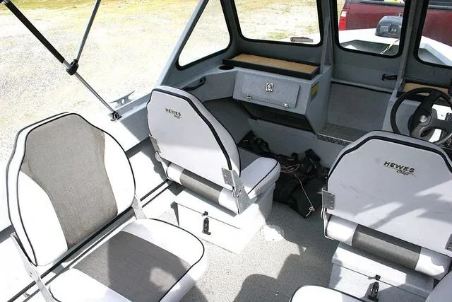 Slide: The Image of 2003 Hewescraft 160 Sportsman boat interior with seating and steering console. - 7