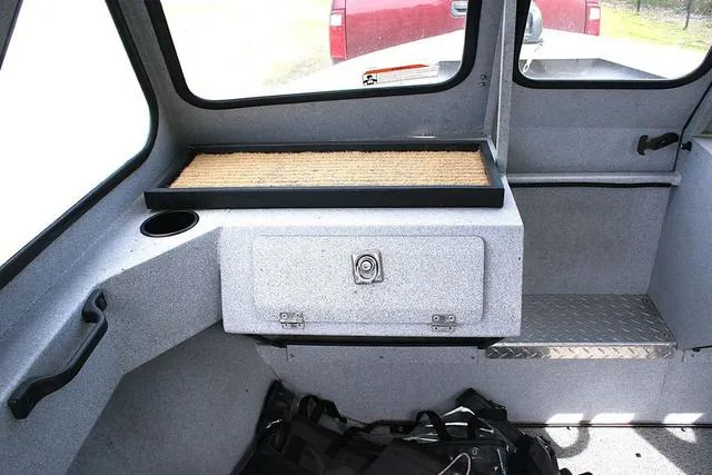 Slide: The Image of Interior of 2003 Hewescraft 160 Sportsman boat with storage compartment and seating area. - 9