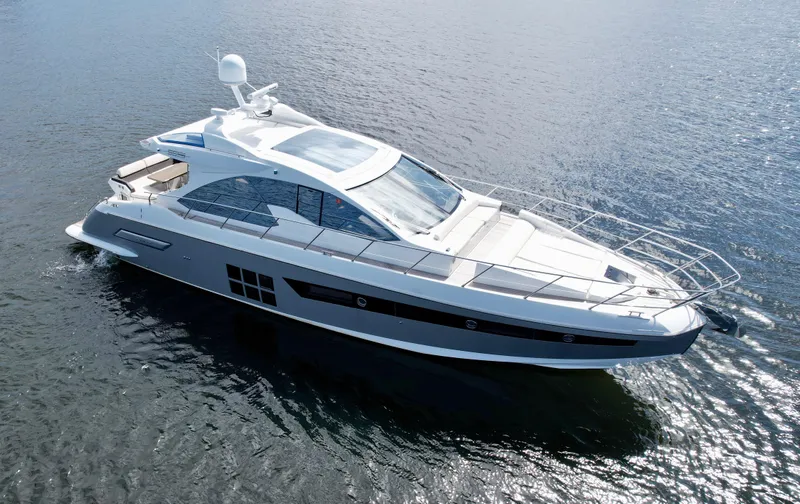 Slide: The Image of 2015 Azimut 55S yacht cruising on open water, showcasing sleek design and luxury features. - 1