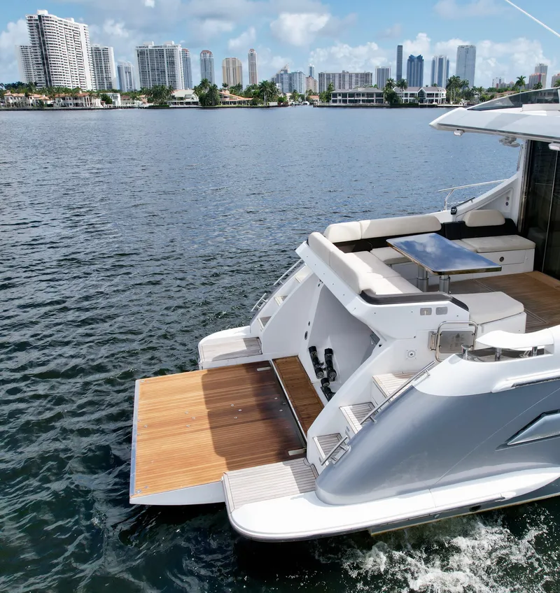Slide: The Image of 2015 Azimut 55S yacht with open deck, city skyline in background. - 19