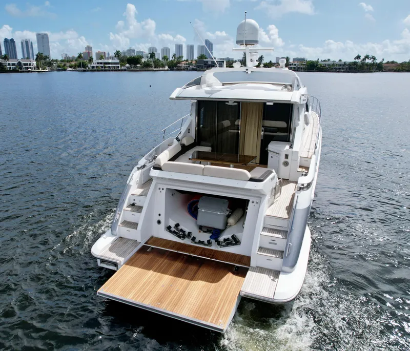 Slide: The Image of 2015 Azimut 55S yacht cruising on calm waters with city skyline in background. - 20