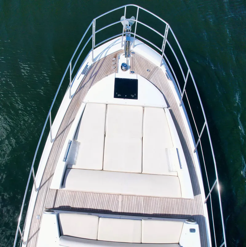 Slide: The Image of 2015 Azimut 55S yacht bow with sunbathing area, sleek design, and elegant railings. - 25