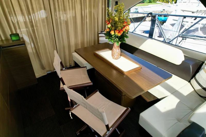 Slide: The Image of Luxurious interior of 2015 Azimut 55S yacht with elegant dining area and floral centerpiece. - 28