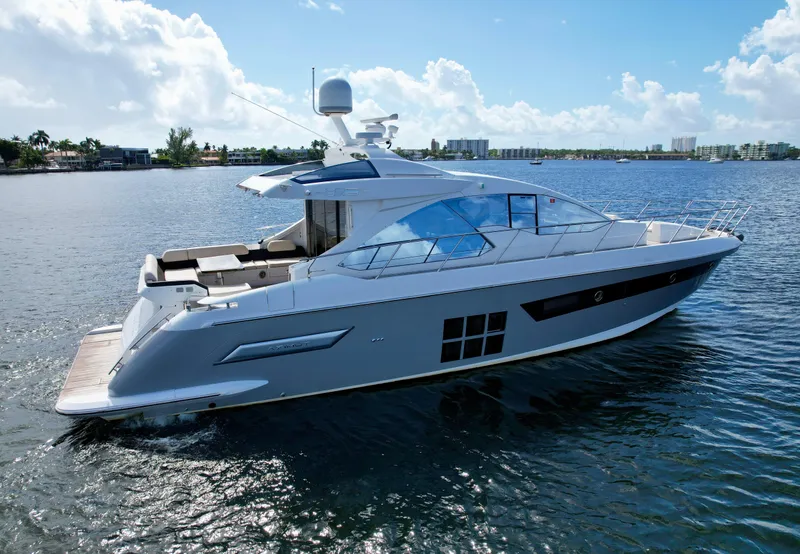 Slide: The Image of 2015 Azimut 55S yacht cruising on a sunny day, showcasing sleek design and luxury features. - 3