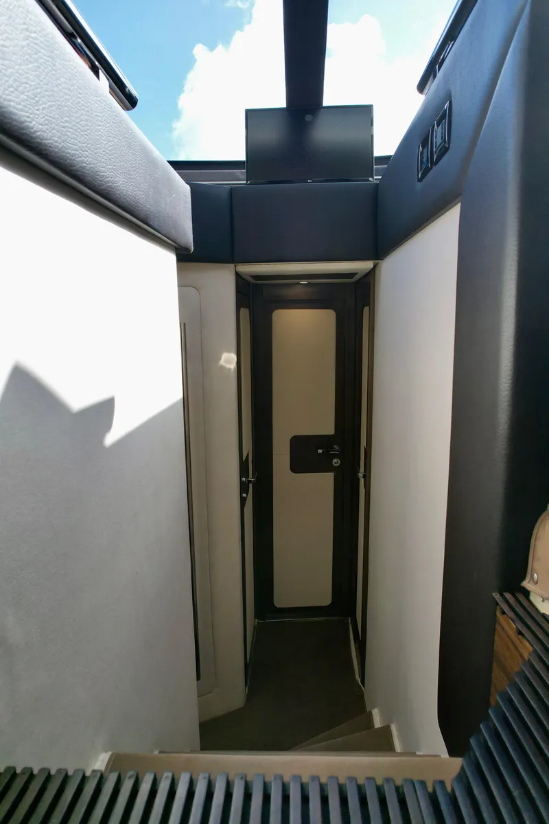 Slide: The Image of Interior view of 2015 Azimut 55S yacht, featuring a sleek, modern stairway design. - 38