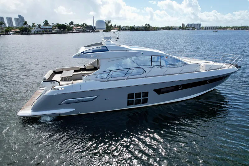 Slide: The Image of 2015 Azimut 55S yacht cruising on a sunny day, showcasing sleek design and luxury. - 4