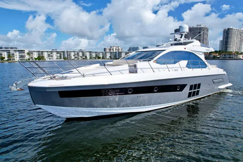 Slide: The Image of 2015 Azimut 55S yacht cruising on water with city skyline in background. - 6