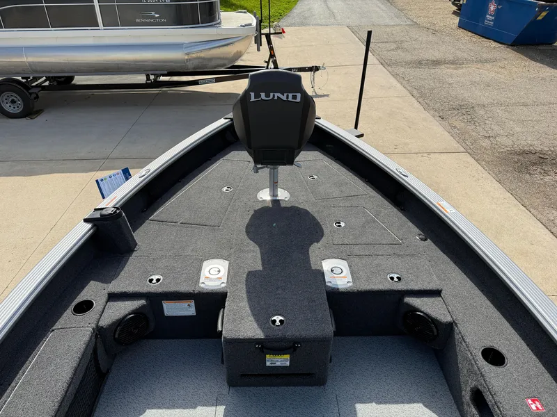 Slide: The Image of 2025 Lund 1875 Pro Guide boat interior with seating and storage compartments. - 10