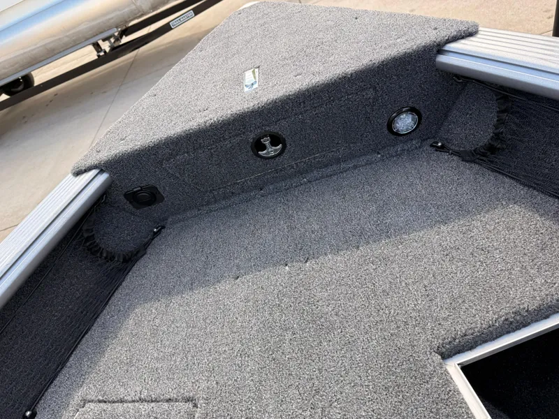 Slide: The Image of 2025 Lund 1875 Pro Guide boat interior with carpeted deck and storage compartments. - 13