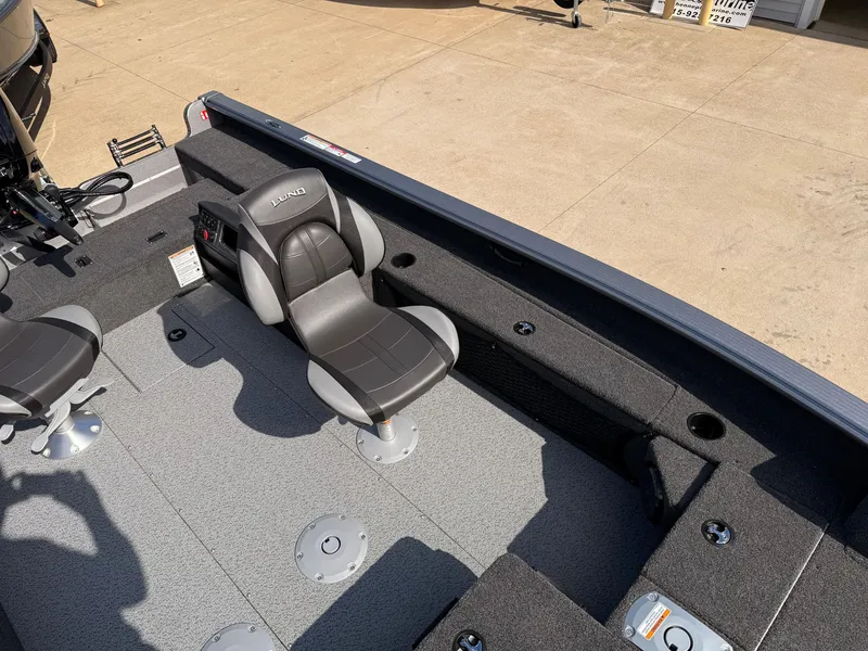Slide: The Image of 2025 Lund 1875 Pro Guide boat interior with gray seating and deck. - 15