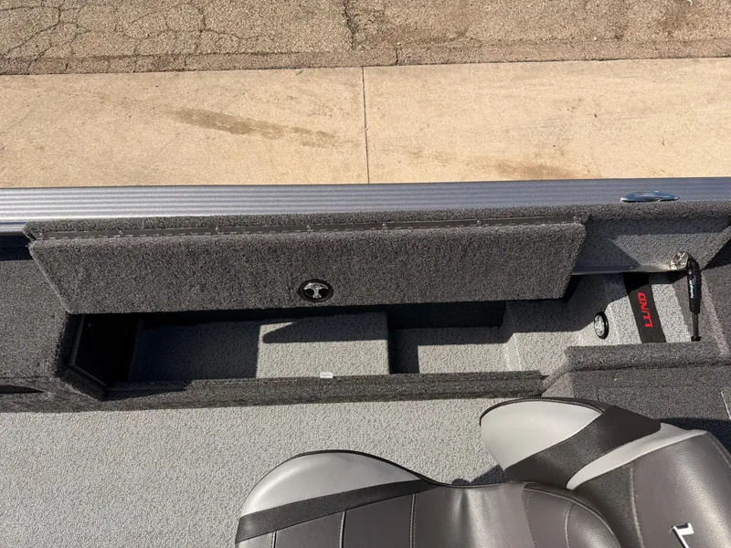 Slide: The Image of 2025 Lund 1875 Pro Guide boat interior with storage compartment and seating. - 17