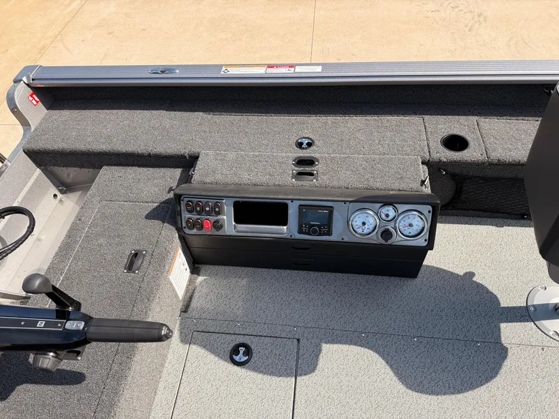 Slide: The Image of 2025 Lund 1875 Pro Guide boat dashboard with gauges and controls. - 18