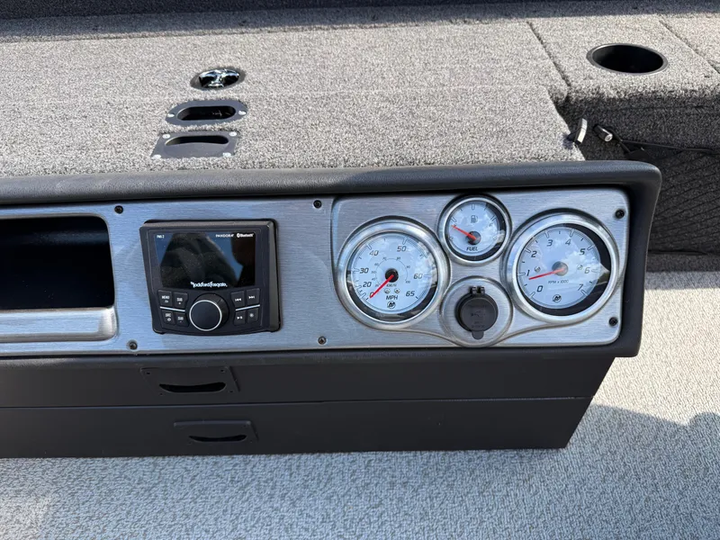 Slide: The Image of 2025 Lund 1875 Pro Guide dashboard with gauges and stereo system. - 19