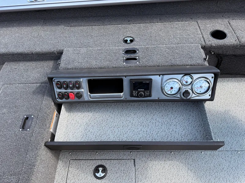 Slide: The Image of 2025 Lund 1875 Pro Guide boat dashboard with gauges and controls. - 21