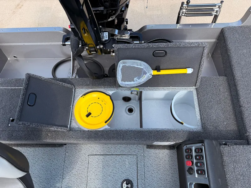 Slide: The Image of 2025 Lund 1875 Pro Guide boat interior with storage compartments and fishing net. - 22