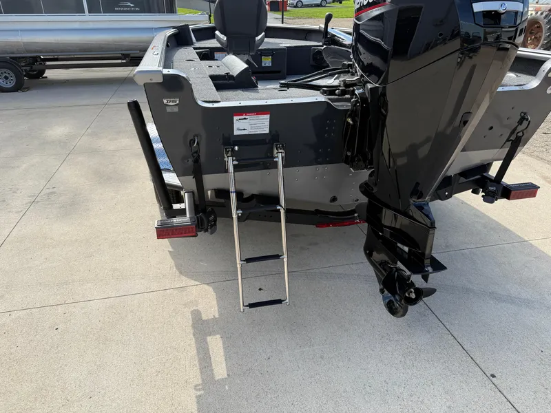 Slide: The Image of 2025 Lund 1875 Pro Guide boat rear view with motor and ladder. - 7