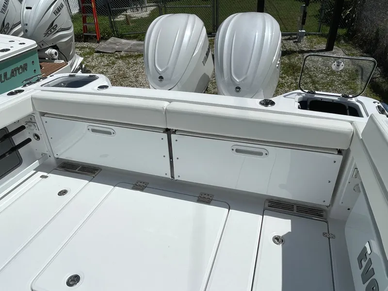 Slide: The Image of 2025 Everglades 315 Center Console boat with dual outboard engines, white seating, and storage compartments. - 11