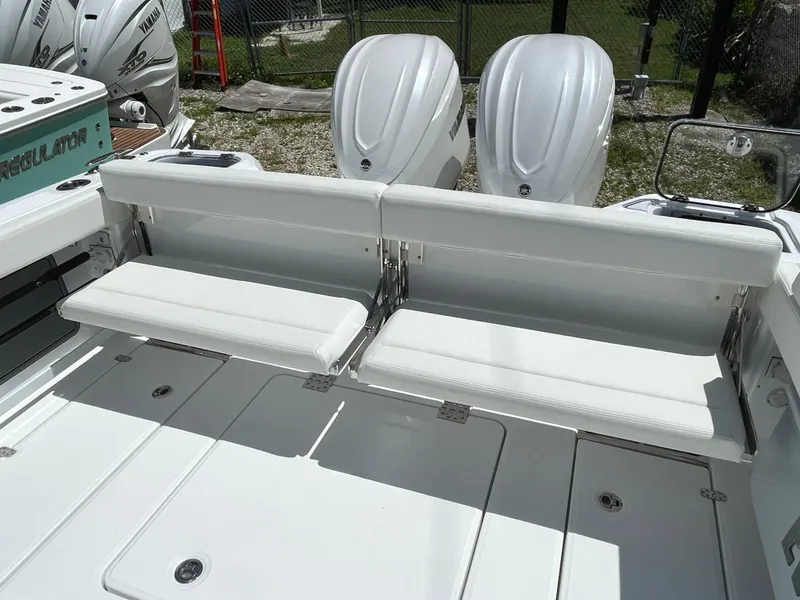 Slide: The Image of 2025 Everglades 315 Center Console boat with dual outboard engines and foldable seating. - 12