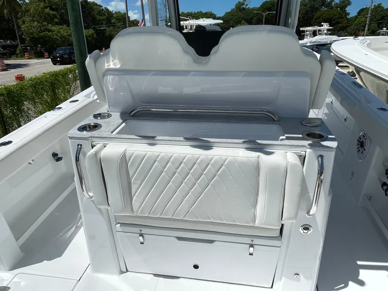 Slide: The Image of 2025 Everglades 315 Center Console boat interior with white seating and storage. - 14