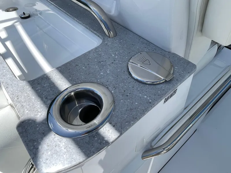 Slide: The Image of 2025 Everglades 315 Center Console boat sink and cup holder detail. - 15