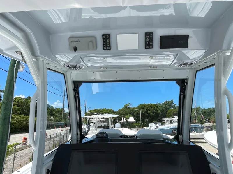Slide: The Image of 2025 Everglades 315 Center Console boat interior with advanced navigation controls. - 18