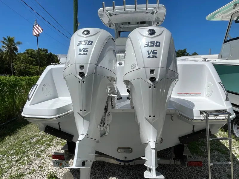 Slide: The Image of 2025 Everglades 315 Center Console with twin 350 V6 outboard engines, rear view. - 2