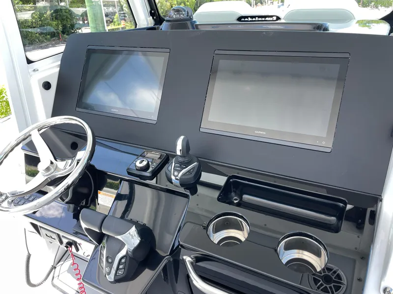 Slide: The Image of 2025 Everglades 315 Center Console dashboard with dual screens and steering wheel. - 20