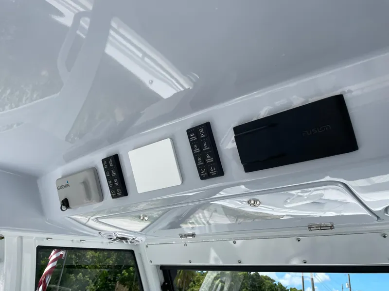 Slide: The Image of Control panel of 2025 Everglades 315 Center Console boat interior. - 21
