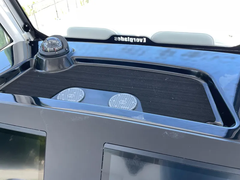 Slide: The Image of 2025 Everglades 315 Center Console dashboard with compass and speakers. - 22