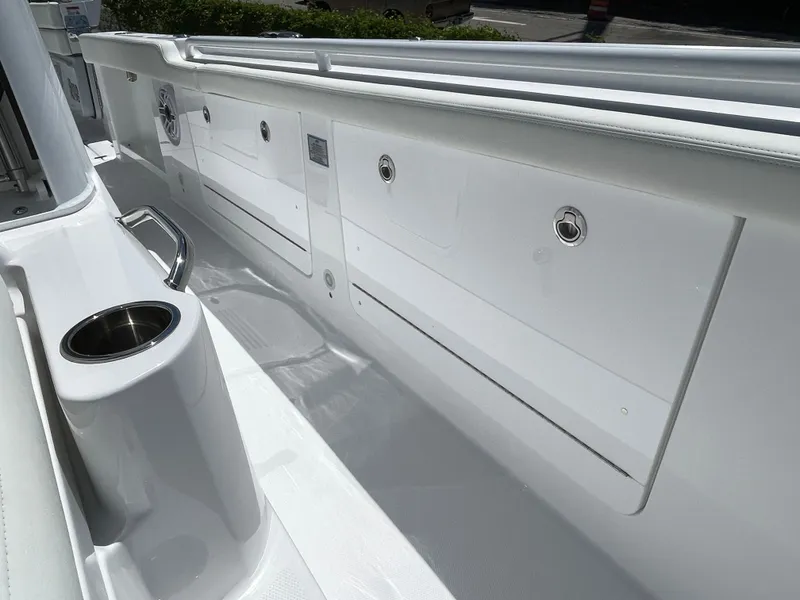 Slide: The Image of 2025 Everglades 315 Center Console boat interior with sleek white design and built-in cup holder. - 32