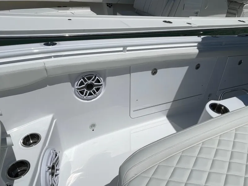 Slide: The Image of 2025 Everglades 315 Center Console boat interior with white seating and speaker system. - 33